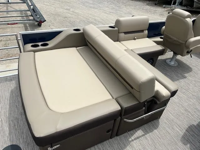Slide: The Image of 2023 Godfrey SWEETWATER 2286 SFL boat interior with beige seating and cup holders. - 8