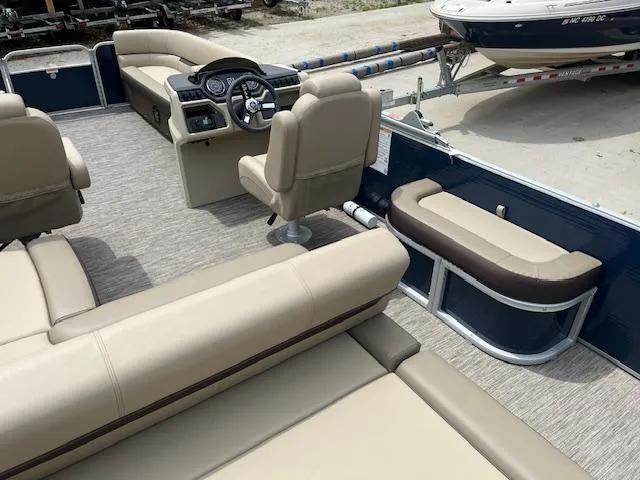 Slide: The Image of 2023 Godfrey SWEETWATER 2286 SFL pontoon boat interior with beige seating and steering console. - 9