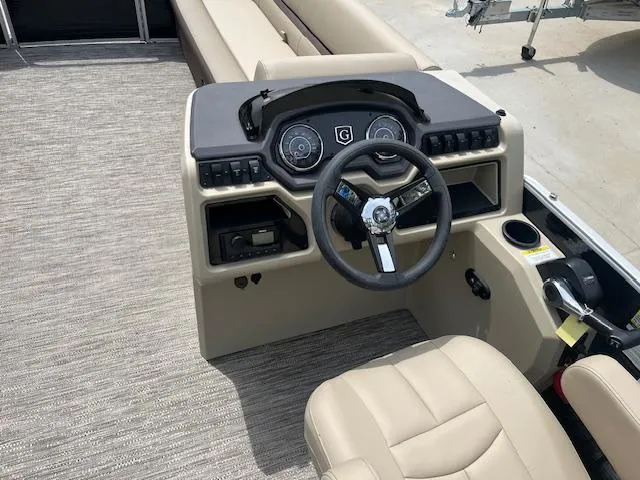 Slide: The Image of 2023 Godfrey SWEETWATER 2286 SFL boat dashboard with steering wheel and controls. - 7