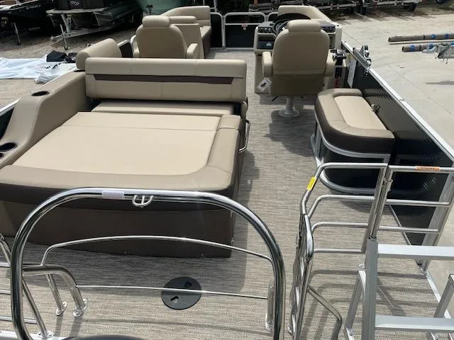 Slide: The Image of 2023 Godfrey SWEETWATER 2286 SFL pontoon boat interior with beige seating and spacious layout. - 9