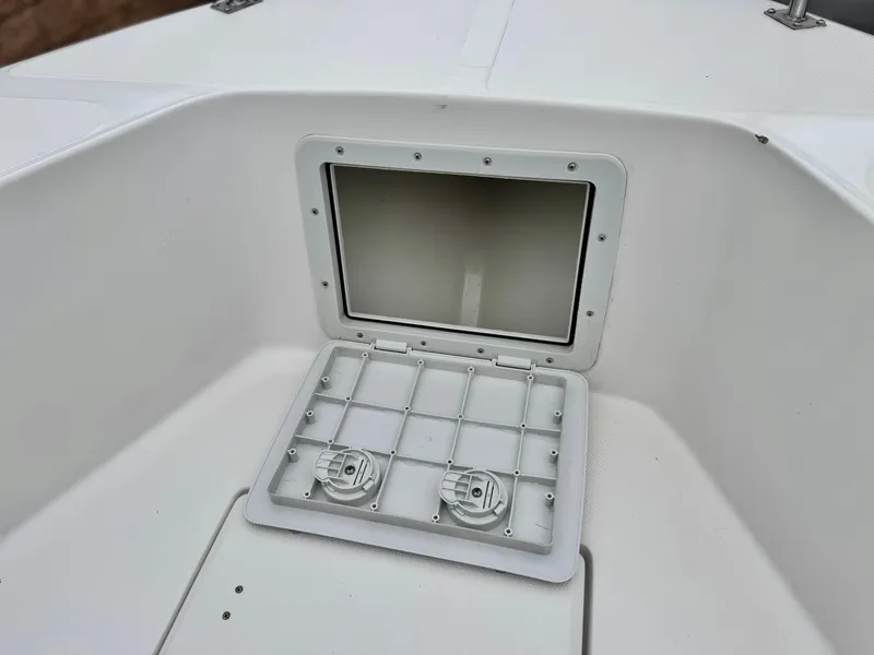 Slide: The Image of 2022 Thresher 25 CC boat storage compartment with open hatch. - 10