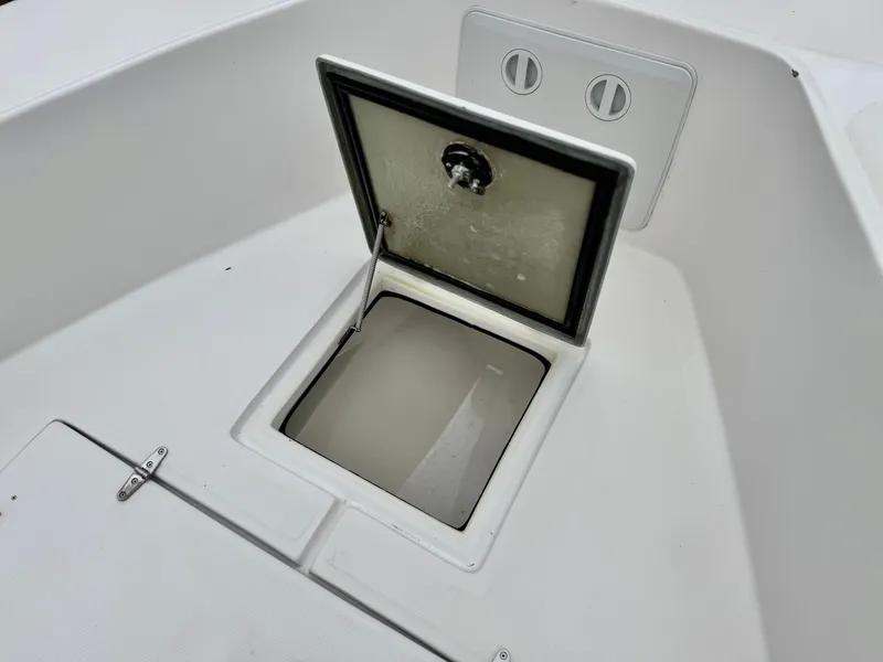 Slide: The Image of Open storage compartment on 2022 Thresher 25 CC boat deck. - 11