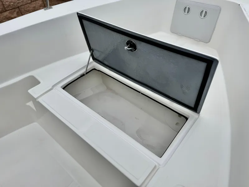 Slide: The Image of Open storage compartment on 2022 Thresher 25 CC boat. - 12
