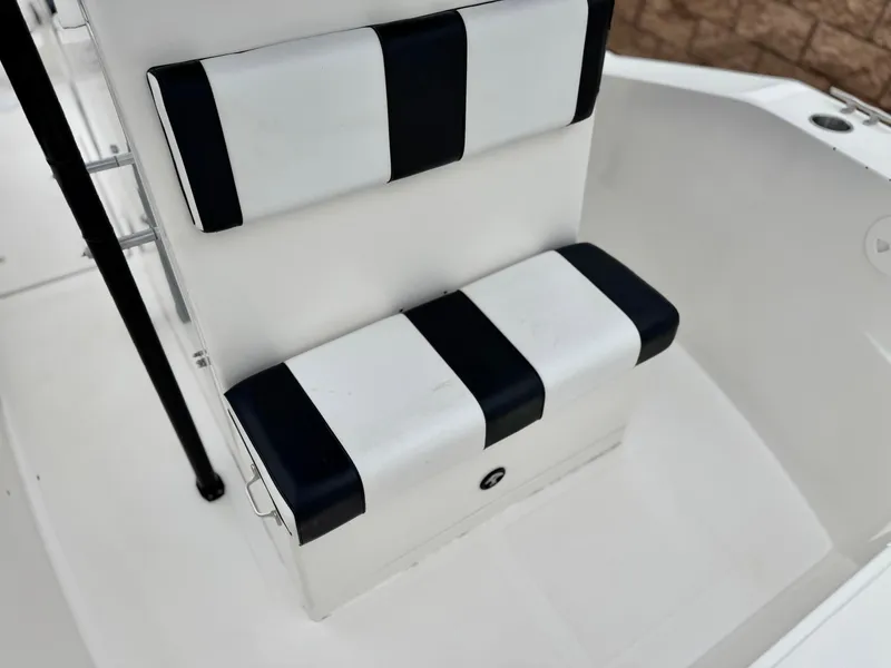 Slide: The Image of 2022 Thresher 25 CC boat seating with black and white striped cushions. - 14