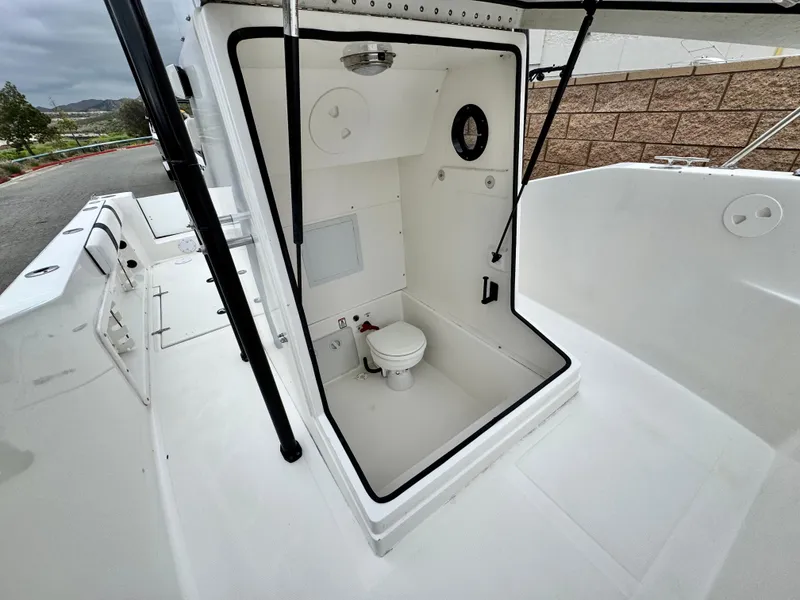 Slide: The Image of 2022 Thresher 25 CC boat with onboard toilet compartment, open deck view. - 15