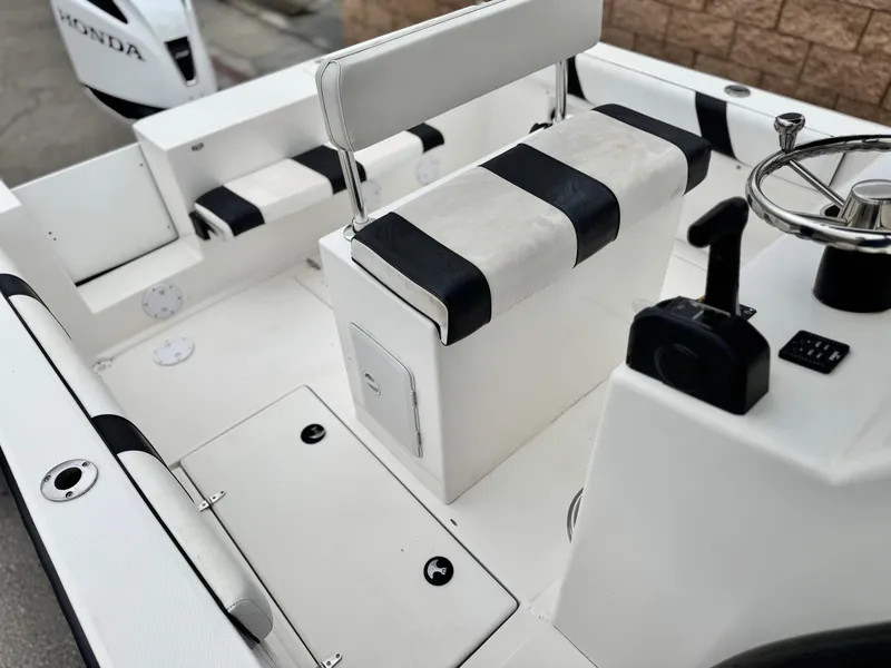 Slide: The Image of 2022 Thresher 25 CC boat interior with steering wheel and seating. - 17