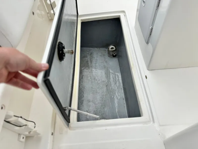 Slide: The Image of Open storage compartment on 2022 Thresher 25 CC boat, showcasing interior space. - 18