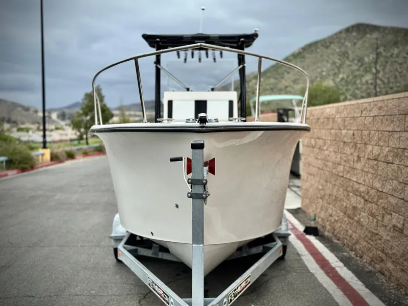 Slide: The Image of 2022 Thresher 25 CC boat on trailer, parked near mountains. - 2