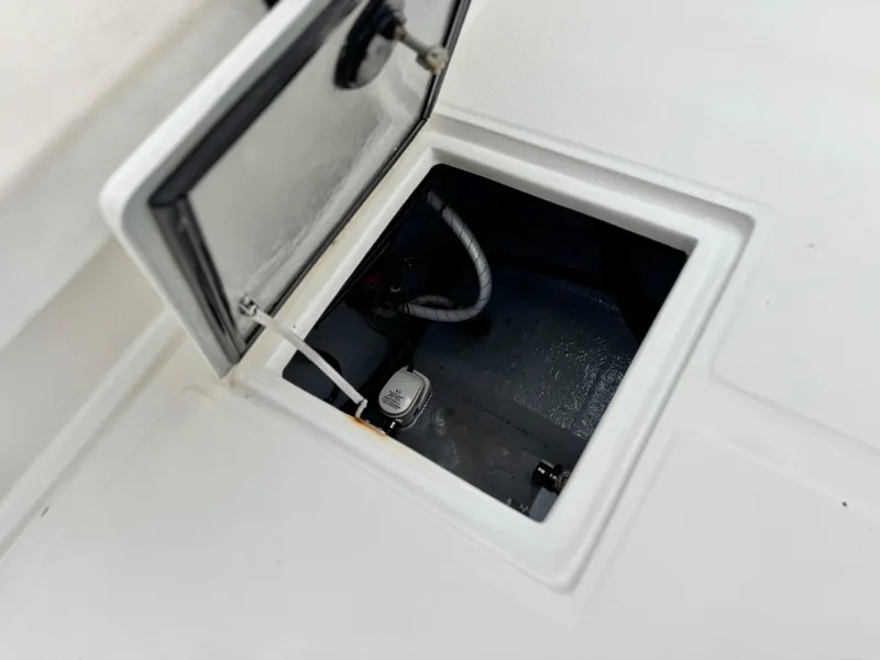 Slide: The Image of Open hatch on 2022 Thresher 25 CC boat, revealing interior compartment. - 20