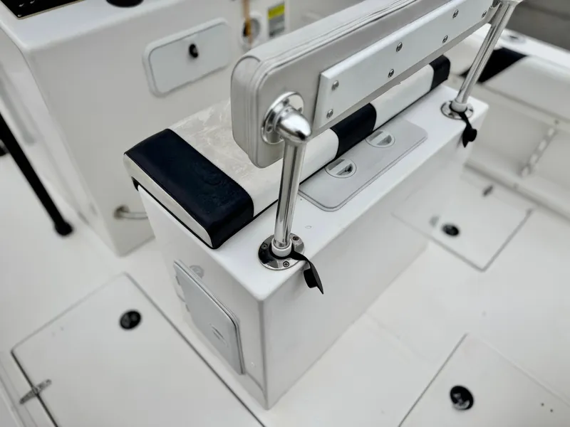 Slide: The Image of 2022 Thresher 25 CC boat interior with sleek white seating and storage compartments. - 22