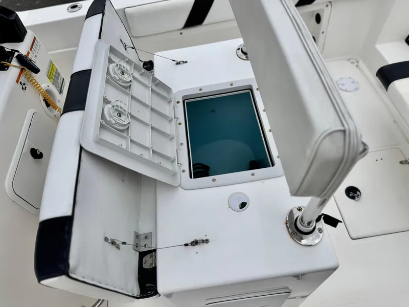 Slide: The Image of Thresher 25 CC 2022 boat interior with open storage compartment and seating. - 23