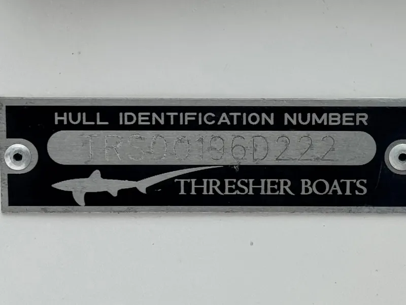 Slide: The Image of Hull identification plate for 2022 Thresher 25 CC boat, featuring shark logo. - 30