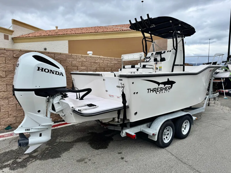 Slide: The Image of 2022 Thresher 25 CC boat with Honda outboard motor on a trailer. - 5