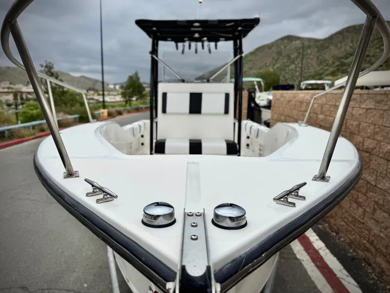 Slide: The Image of 2022 Thresher 25 CC boat with sleek design, docked outdoors. - 7