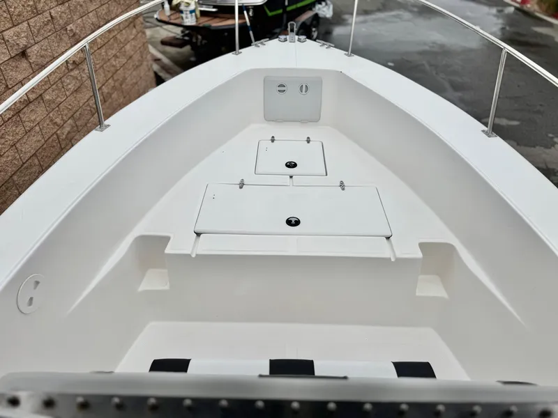 Slide: The Image of 2022 Thresher 25 CC boat interior with storage compartments and seating. - 9
