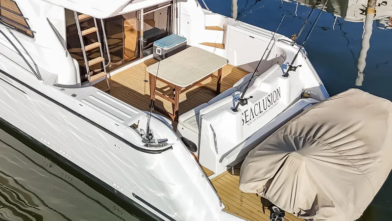 Slide: The Image of 1997 Viking Princess 60 Flybridge yacht with outdoor seating and fishing rods. - 11
