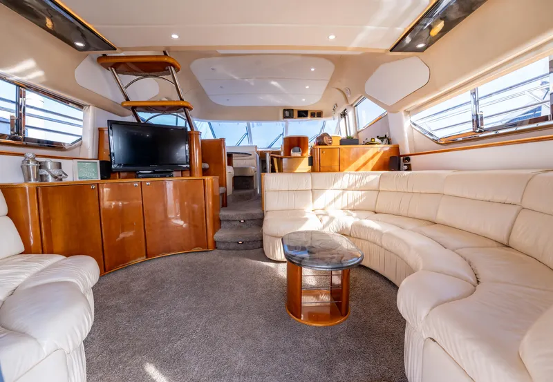 Slide: The Image of Luxurious interior of 1997 Viking Princess 60 Flybridge yacht with plush seating and modern amenities. - 21