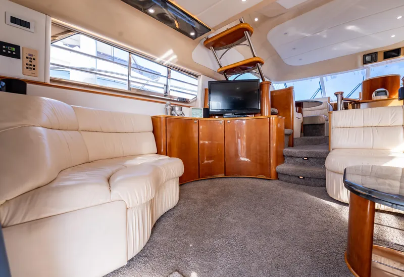Slide: The Image of Luxurious 1997 Viking Princess 60 Flybridge yacht interior with plush seating and entertainment area. - 23