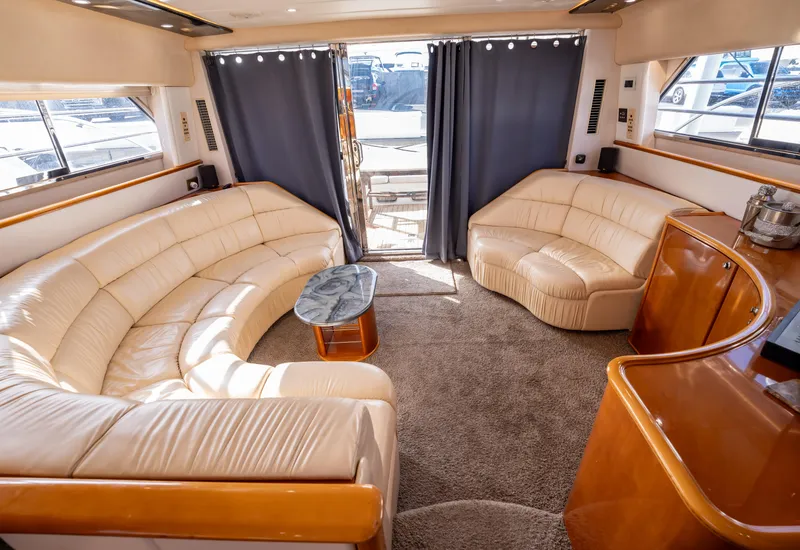 Slide: The Image of Luxurious interior of 1997 Viking Princess 60 Flybridge yacht with plush seating and elegant decor. - 25