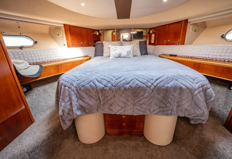Slide: The Image of Luxurious bedroom interior of 1997 Viking Princess 60 Flybridge yacht with cozy bedding. - 30