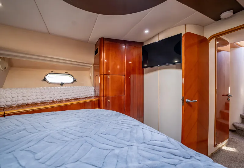 Slide: The Image of Luxurious cabin interior of 1997 Viking Princess 60 Flybridge yacht with wood finishes. - 31