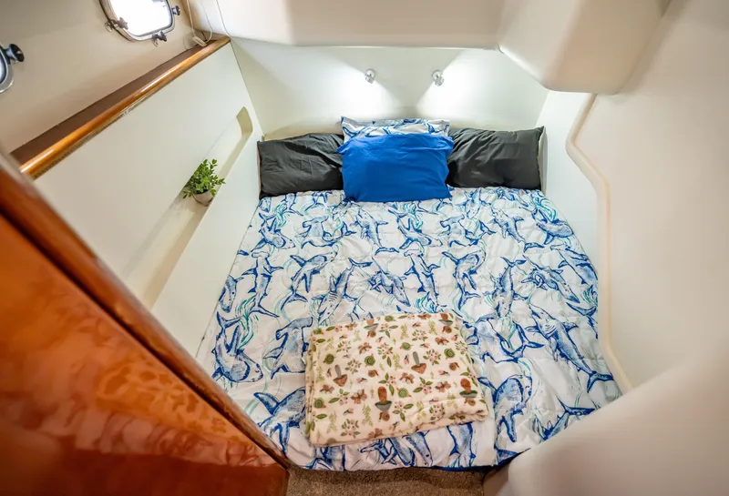 Slide: The Image of Cozy bedroom in 1997 Viking Princess 60 Flybridge yacht with nautical-themed bedding. - 33