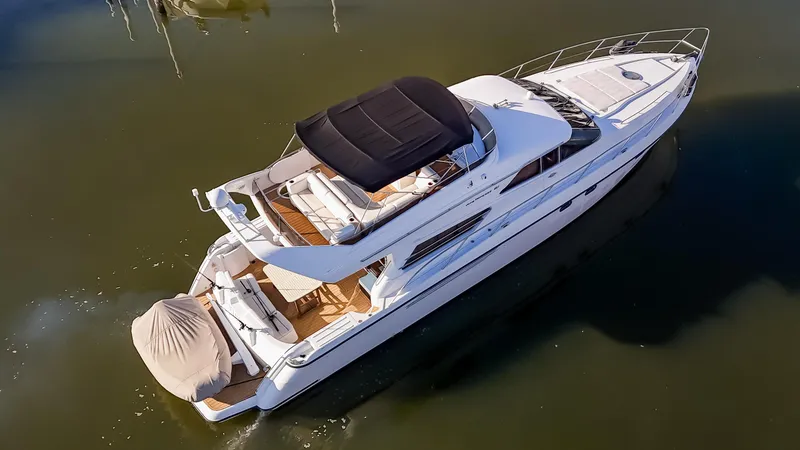 Slide: The Image of 1997 Viking Princess 60 Flybridge yacht on calm water, aerial view. - 5