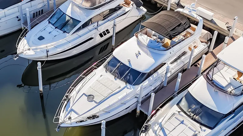 Slide: The Image of 1997 Viking Princess 60 Flybridge yacht docked among other luxury boats. - 9