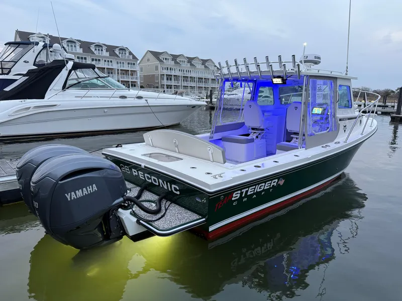 Slide: The Image of 2024 Steiger Craft 28 Peconic boat docked, featuring Yamaha engine and illuminated interior. - 1