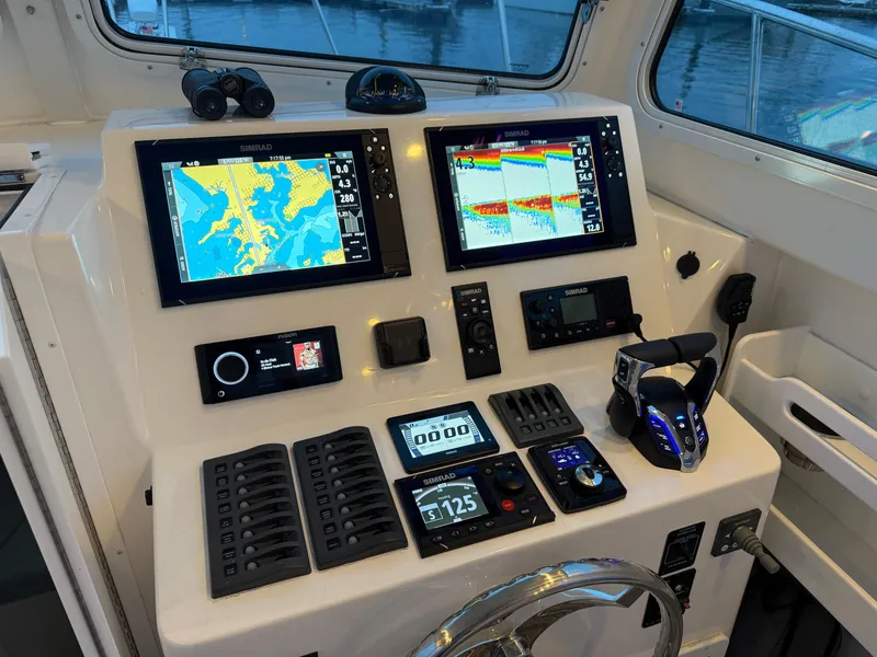 Slide: The Image of 2024 Steiger Craft 28 Peconic boat dashboard with advanced navigation and control systems. - 12