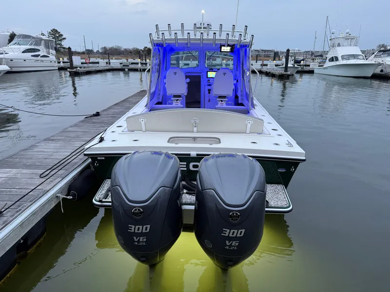 Slide: The Image of 2024 Steiger Craft 28 Peconic boat with dual 300 HP engines docked at marina. - 2