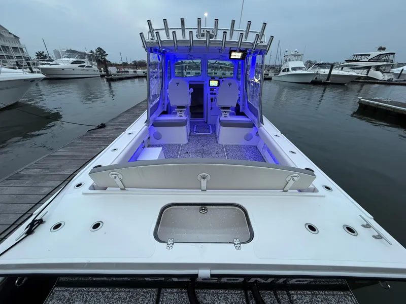 Slide: The Image of 2024 Steiger Craft 28 Peconic boat docked, featuring illuminated interior and spacious deck. - 7