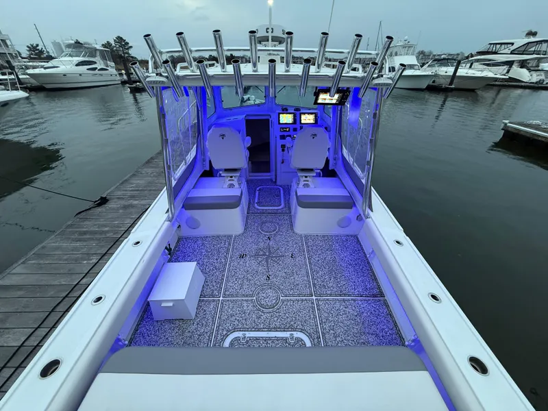 Slide: The Image of 2024 Steiger Craft 28 Peconic boat interior with blue LED lighting at marina. - 8