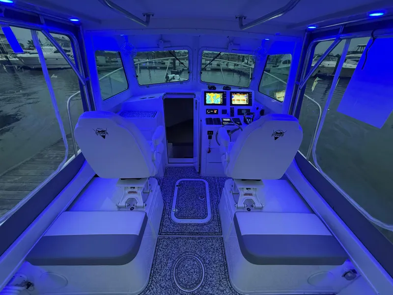 Slide: The Image of 2024 Steiger Craft 28 Peconic boat interior with blue lighting and advanced navigation system. - 9