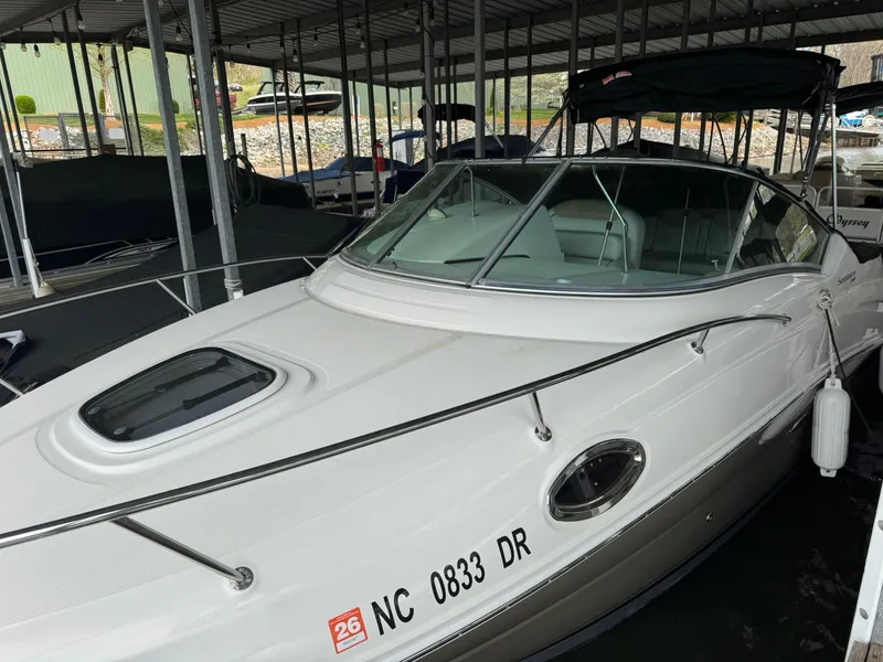 Slide: The Image of 2009 Sea Ray 240 Sundancer boat docked in a covered marina. - 11