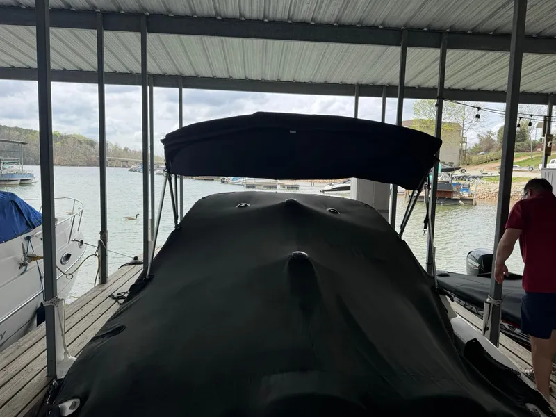 Slide: The Image of 2009 Sea Ray 240 Sundancer covered at dock, scenic lake view. - 12