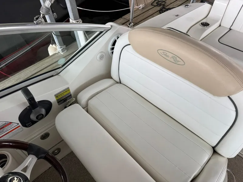 Slide: The Image of 2009 Sea Ray 240 Sundancer boat interior with beige and white seating. - 13