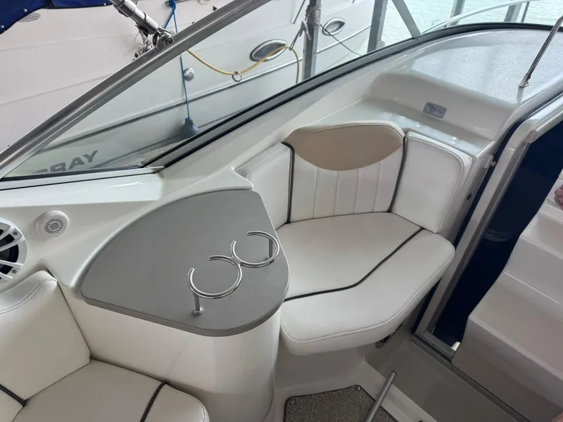 Slide: The Image of 2009 Sea Ray 240 Sundancer interior with white seating and cup holders. - 17