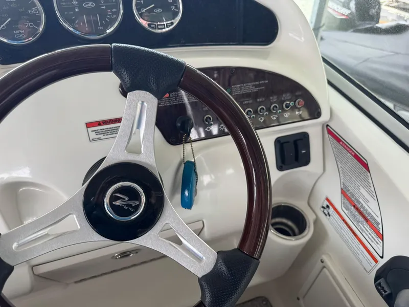 Slide: The Image of Steering wheel and dashboard of 2009 Sea Ray 240 Sundancer boat. - 20