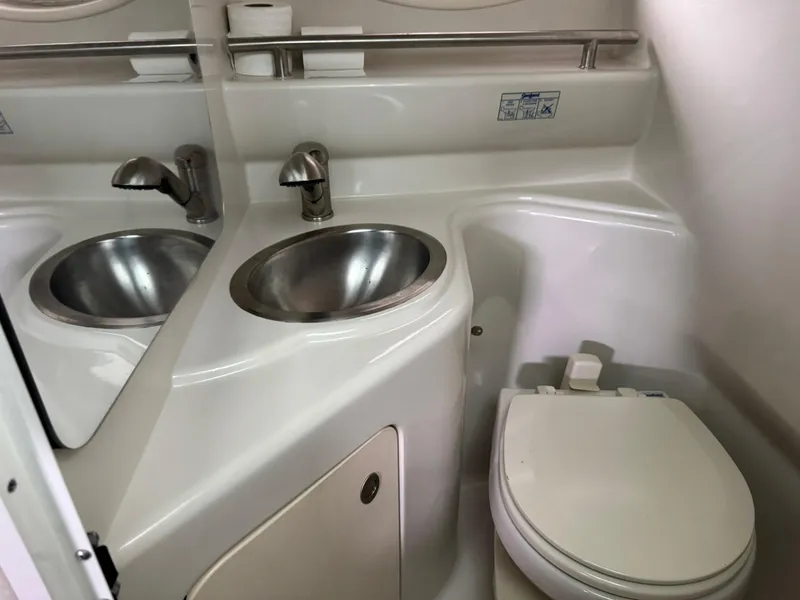 Slide: The Image of 2009 Sea Ray 240 Sundancer bathroom with sink and toilet. - 29