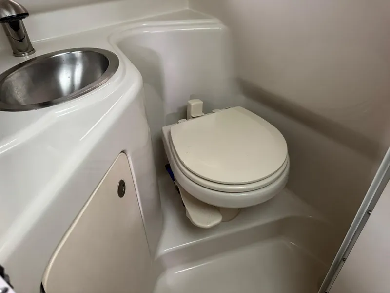 Slide: The Image of 2009 Sea Ray 240 Sundancer boat bathroom with sink and toilet. - 30