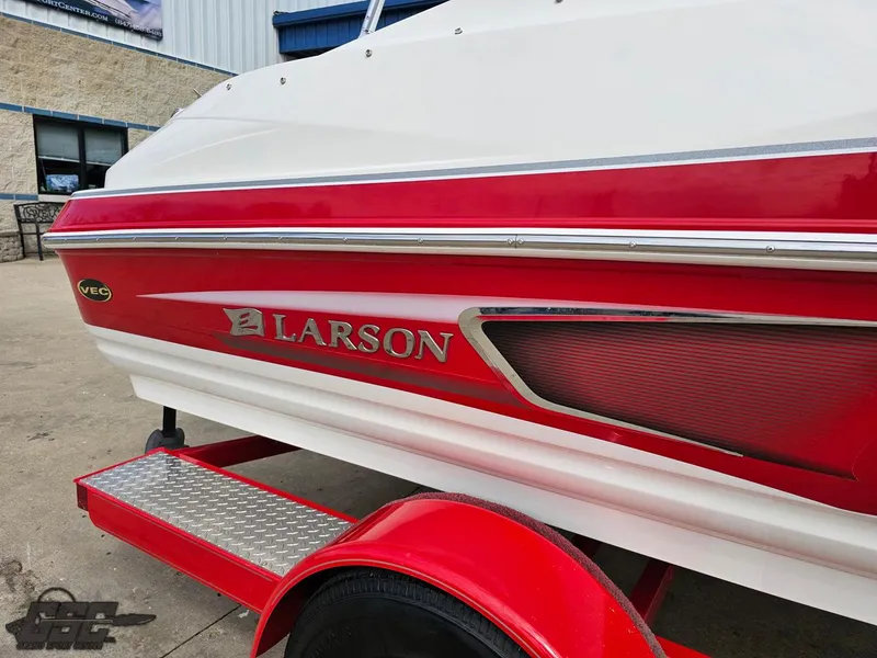 Slide: The Image of 2010 Larson Senza 186 boat with red and white design on a trailer. - 10