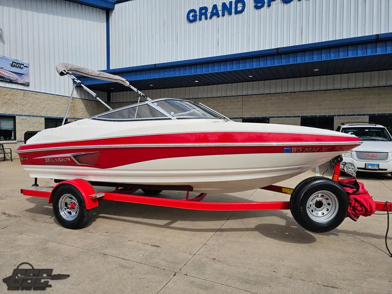 Slide: The Image of 2010 Larson Senza 186 boat with red and white design on a trailer. - 11