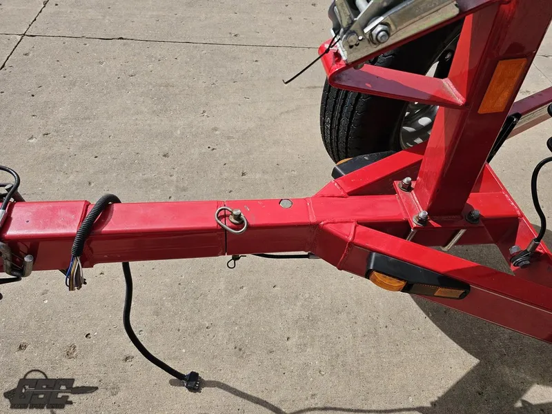 Slide: The Image of Red boat trailer hitch for 2010 Larson Senza 186 on concrete surface. - 16