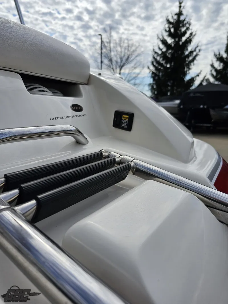 Slide: The Image of 2010 Larson Senza 186 boat with stainless steel ladder and sleek white design. - 32