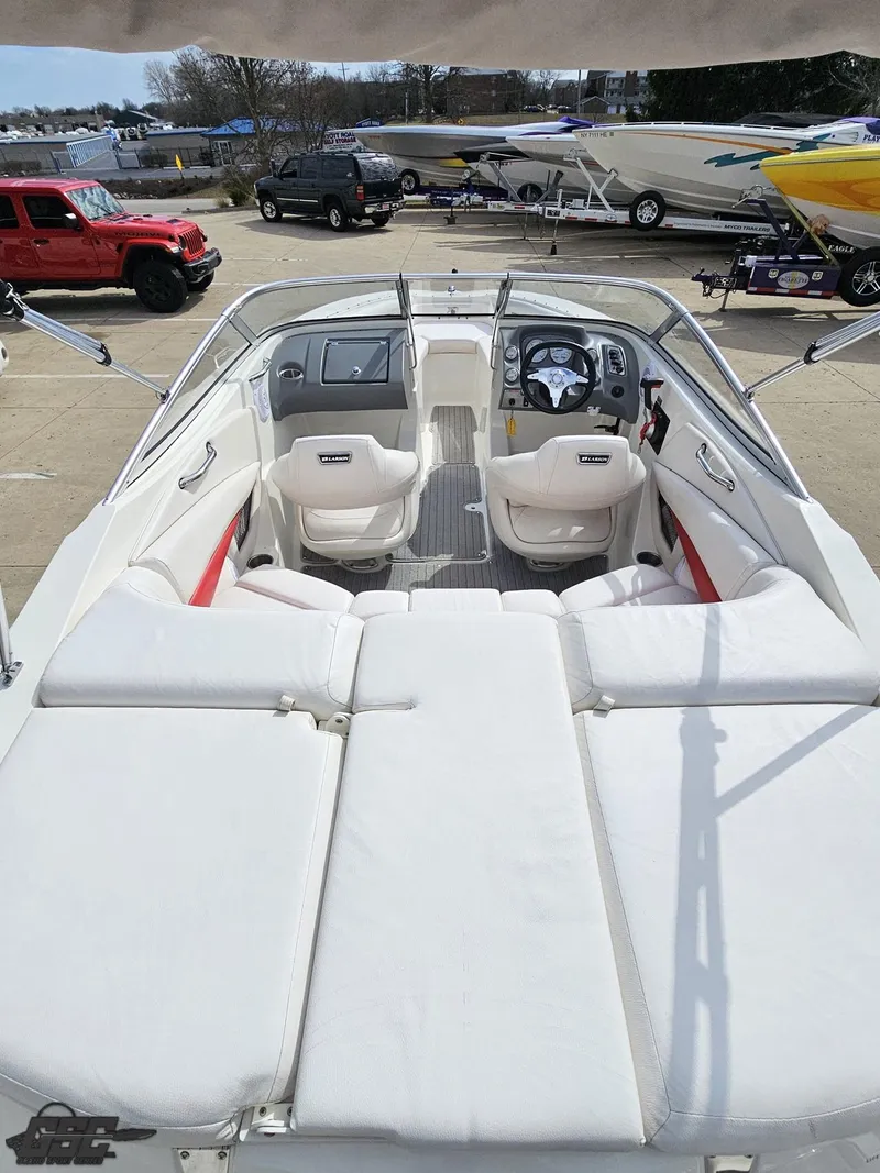 Slide: The Image of 2010 Larson Senza 186 boat interior with white seating and dashboard view. - 34