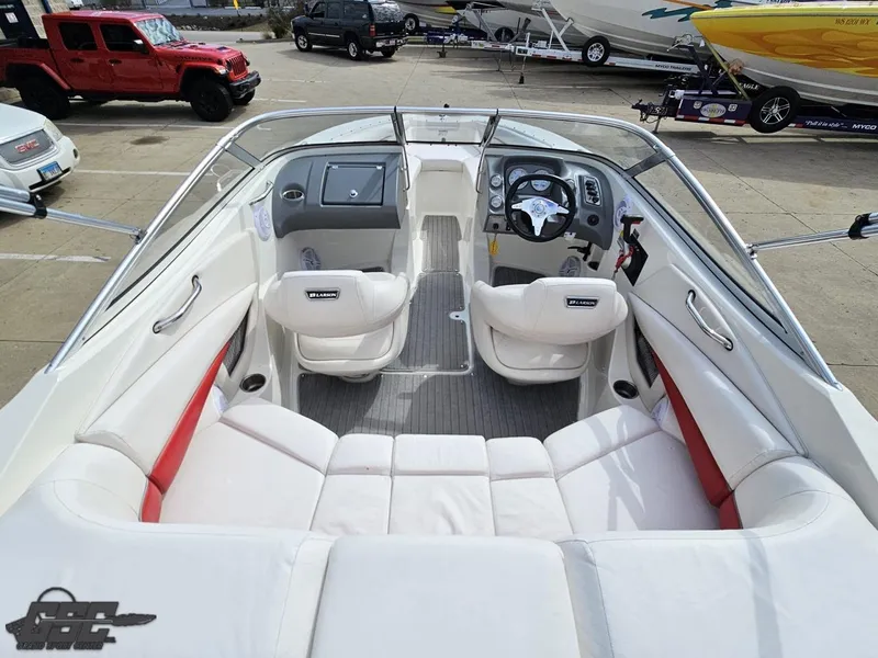 Slide: The Image of 2010 Larson Senza 186 boat interior with white seating and steering console. - 35