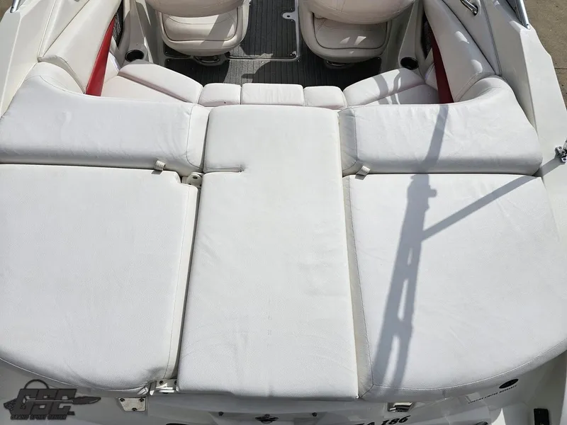 Slide: The Image of 2010 Larson Senza 186 boat with white cushioned seating and red accents. - 36