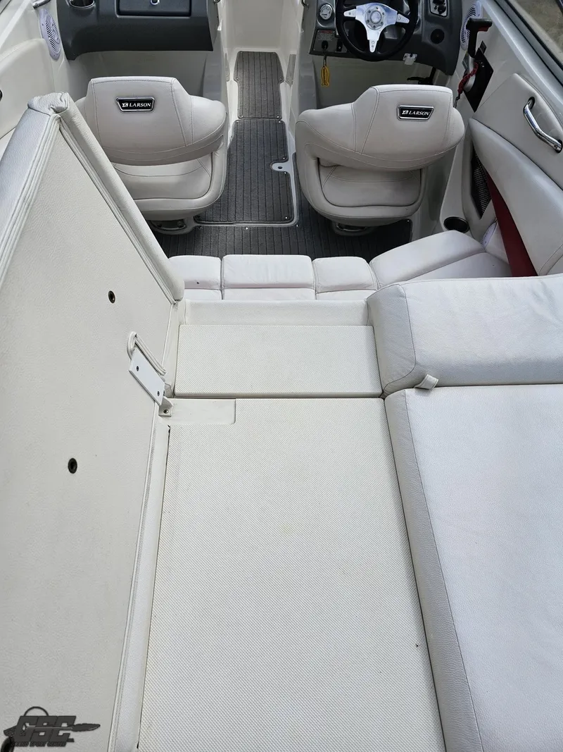 Slide: The Image of 2010 Larson Senza 186 boat interior with white seating and modern dashboard. - 40