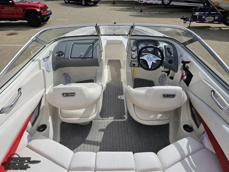 Slide: The Image of 2010 Larson Senza 186 boat interior with white seating and modern dashboard controls. - 41